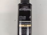 a close up of a bottle of hair dye on a white surface