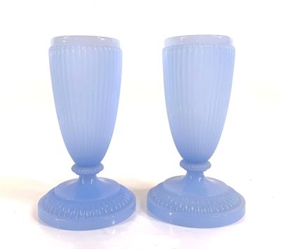 two blue vases sitting on a white surface
