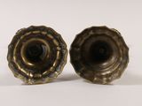 pair of antique brass candlesticks on a white background