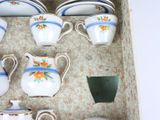 a box with a variety of tea and coffee cups and saucers in it