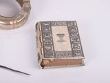 a book and a pair of scissors sitting on a table