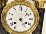 a black and gold clock with roman numerals on it