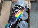 a can of spray paint sitting in a cardboard box
