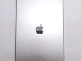 an apple ipad sitting on top of a white table next to a white wall
