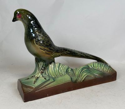 a bird that is sitting on top of a wooden base