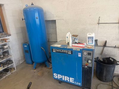 an image of a room with a blue water heater and other items