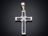 a white gold cross with blue sapphires and diamonds on a black background