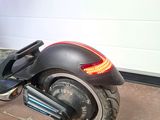 a scooter that is parked in front of a garage door