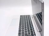 a silver laptop with a black keyboard on a white surface