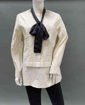 an image of a mannequin dressed in a white shirt and black tie
