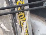 a close up of a metal object with a yellow sticker on it
