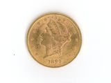 a gold coin on a white surface with a white background