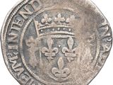 a close up of a coin with a crown on it