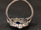 a close up of a silver ring with a blue stone in it