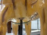 a statue of an elephant on display in a glass case