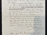 an old piece of paper with writing on it sitting on a table