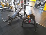 a gym with a bench, weights, and other equipment in the room