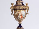 a vase that is sitting on a pedestal on a white surface