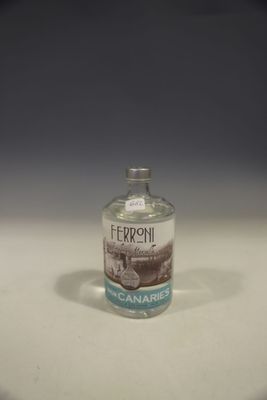 a small bottle of alcohol sitting on a table