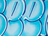 a picture of a blue and white wall with graffiti on it
