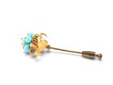an image of a gold and turquoise flower broocher