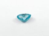 a close up of a blue diamond on a white surface