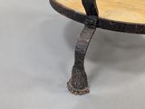 a small table with a wooden top on a grey floor