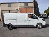 a picture of a white van parked in front of a building
