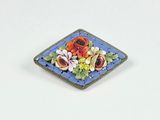 a small plate with flowers on it on a white surface