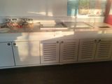 a sink in the middle of a kitchen with a lot of counter space
