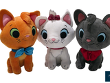 three stuffed animals sitting next to each other on a white background