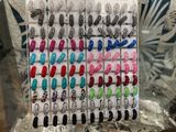a lot of different colors of nail polish on display