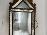 a mirror hanging on the wall in the corner of a room