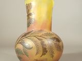 a vase with a design on it sitting on a table