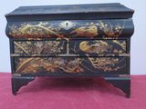 a black and gold chest of drawers with birds on it
