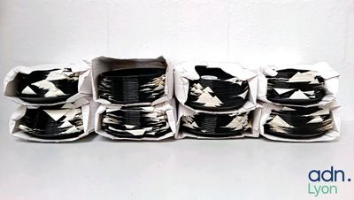 a lot of black and white bowls and cups on the table