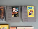 three nintendo game cartridges sitting next to each other on top of a table