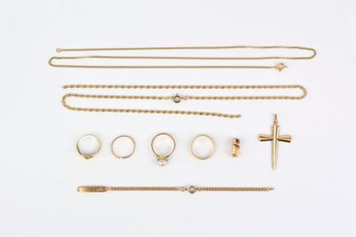 an assortment of gold jewellery including a cross, bracelets, and rings
