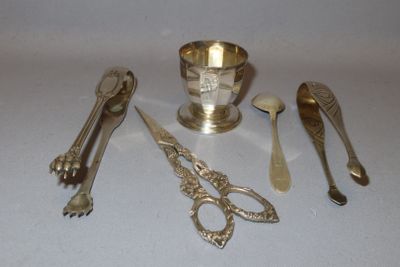 a lot of silver spoons and other silverware on a table