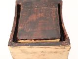 a small wooden box with a lid on a white surface