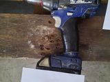 an image of a drill and a hammer on a piece of wood