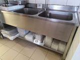 two sinks in the kitchen with towels on the counter