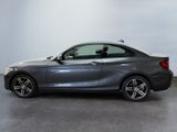 the bmw m140i coupe is parked in a showroom