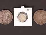 three coins are shown next to each other on a black surface