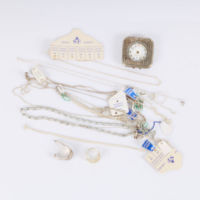 several pieces of jewelry including a clock, bracelets, and a necklace