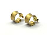 a pair of gold earrings on a white background