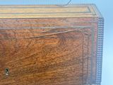 a small wooden box with a key on top of it