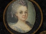 portrait of a woman in a blue dress with a fan in her hand