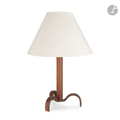 a wooden table lamp with a white shade on top of it