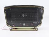 an old fashioned radio sitting on a stand on a white surface